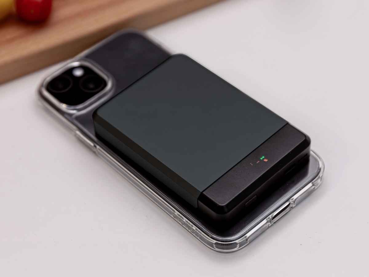 Slide 6: Cygnett MagSlim 10k Powerbank Top view shown attached to a phone resting on a kitchen bench. In black colour.
