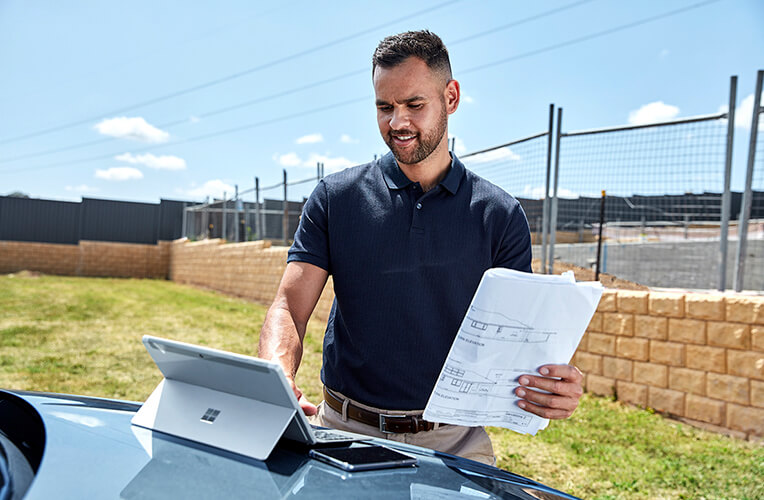 Business customer using laptop connected to a Mobile Broadband device.