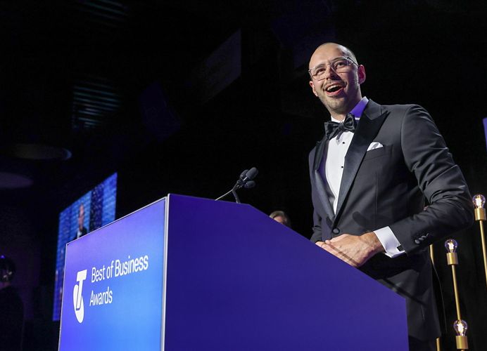 A person standing at a podium speaking into a microphone