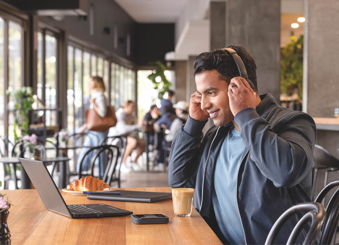 Business customer with laptop connected to Telstra Mobile Broadband device.