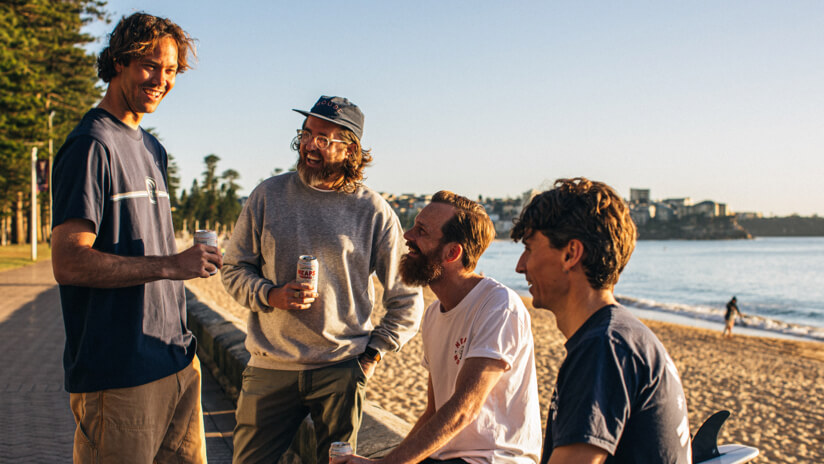 The four founders of drink brand Heaps Good, sitting and drinking