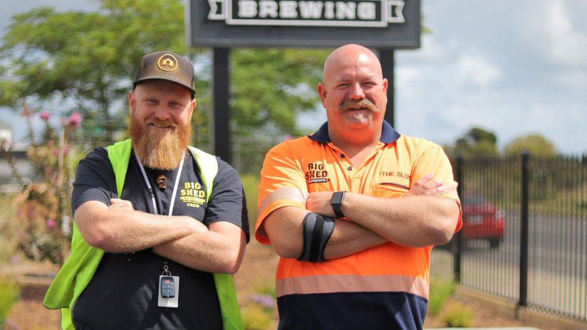 Craig Basford and Jason Harris, co-founders and directors of Big Shed Brewing, stand in front of their business’s sign.