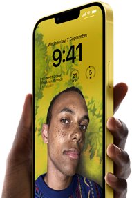 A hand holding an iPhone 14 Plus in yellow displaying a personalised Lock Screen.