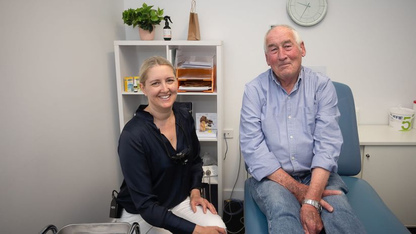 Lisa Hellwege sitting next to a patient